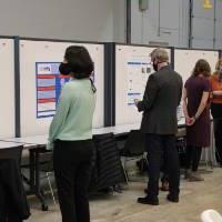 Presenters in front of boards